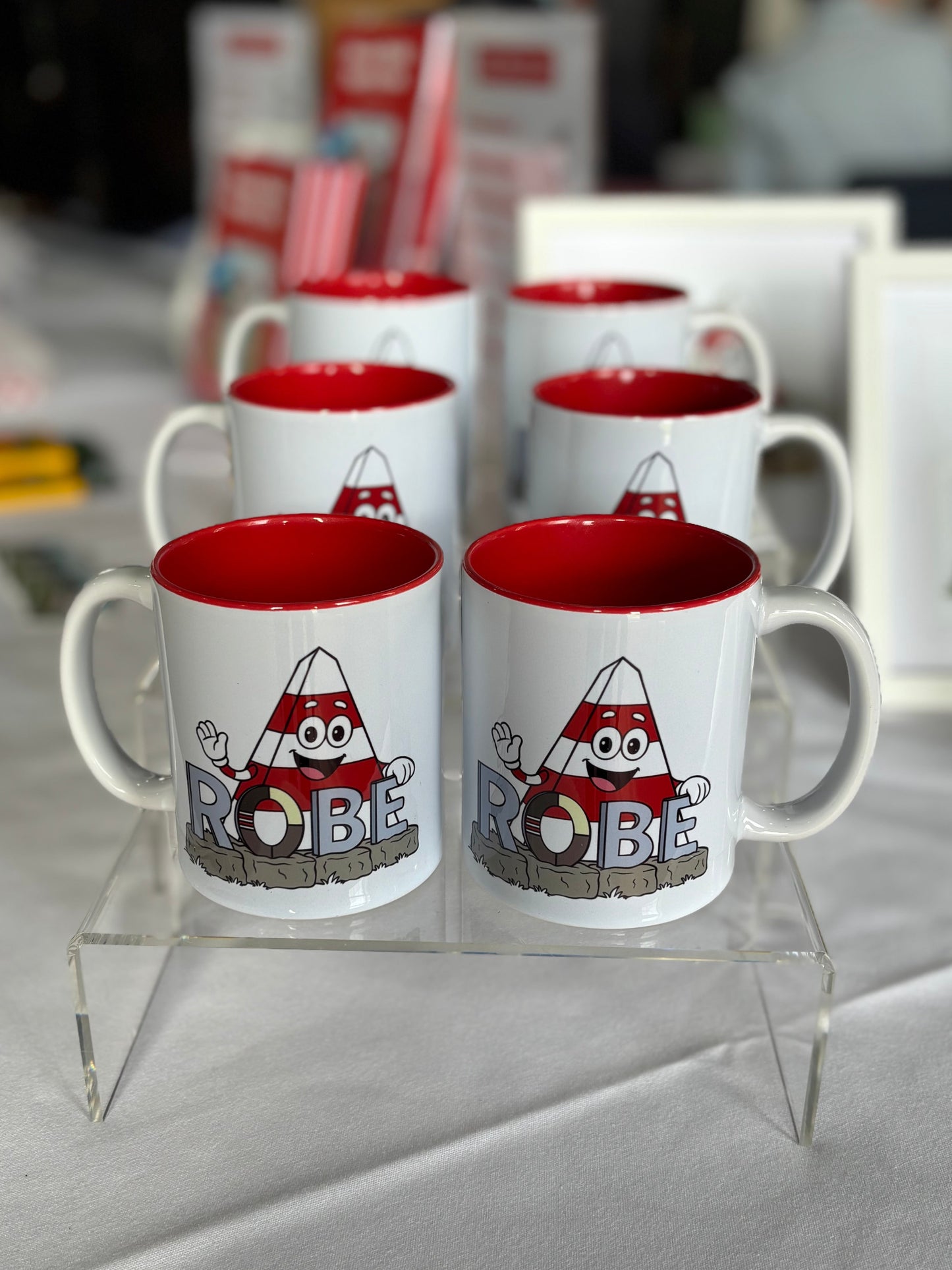 Selection of Obie the Obelisk mugs with the ROBE South Australia sign.
